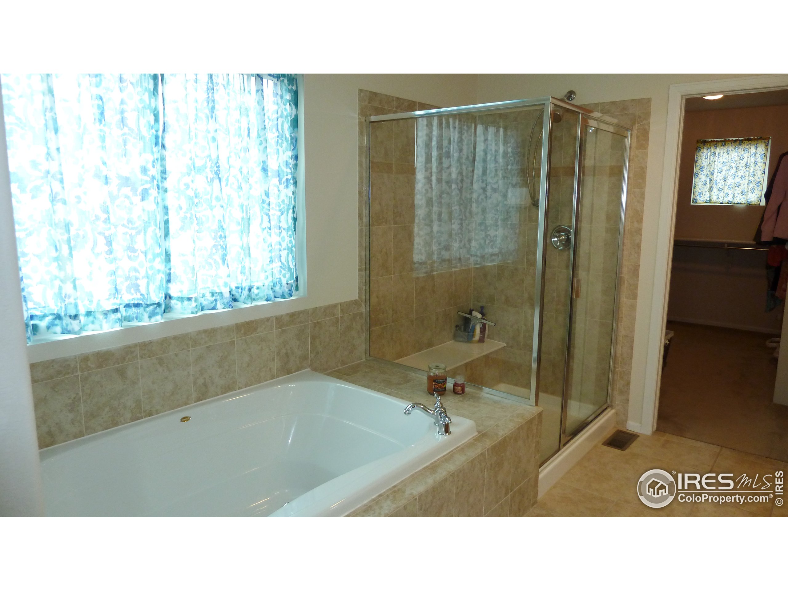 8121 Raspberry Drive Frederick, CO 80504 - Photo 22 of 38 a bathroom with a sink a toilet and shower