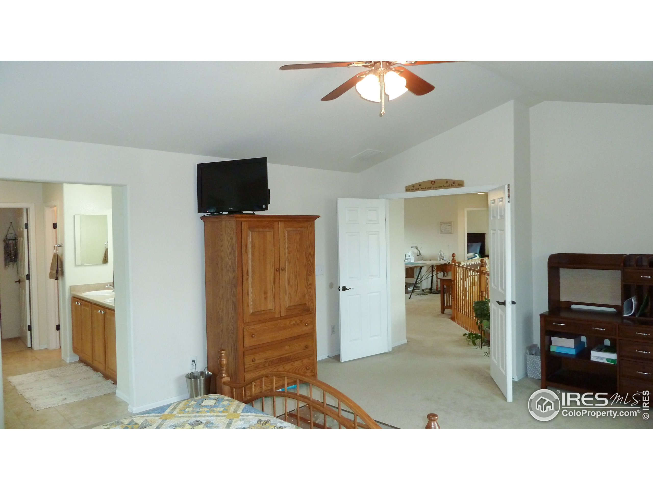 8121 Raspberry Drive Frederick, CO 80504 - Photo 25 of 38 a living room with furniture and a flat screen tv