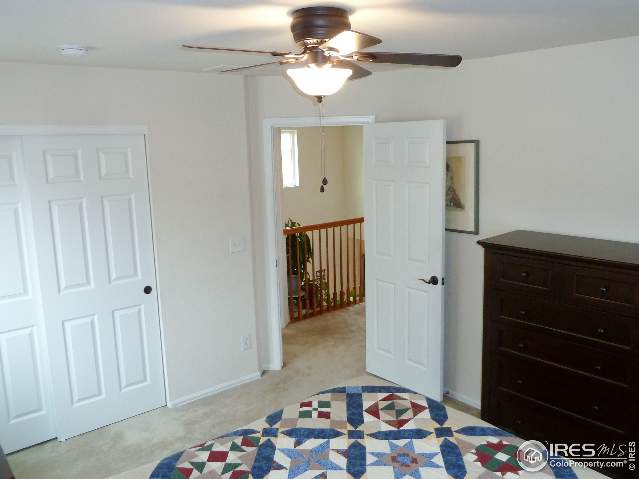 8121 Raspberry Drive Frederick, CO 80504 - Photo 28 of 38 a bedroom with a bed and a chandelier