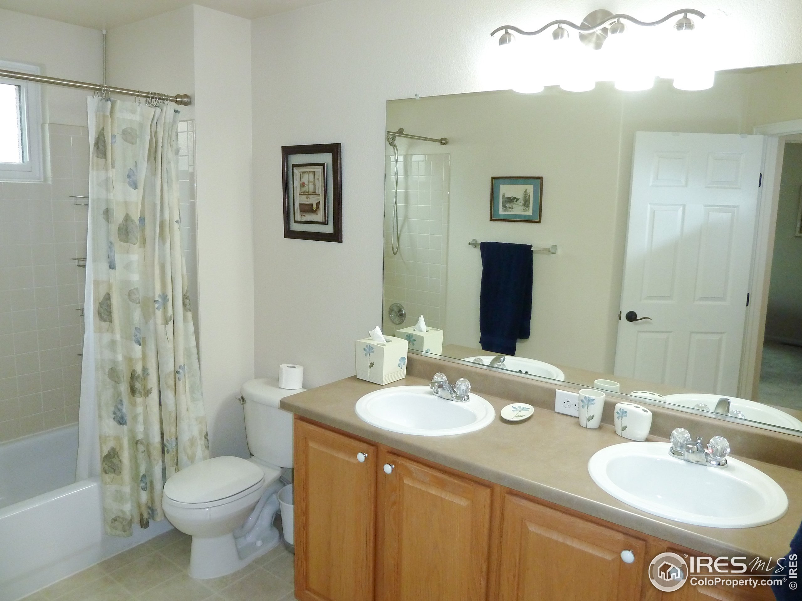 8121 Raspberry Drive Frederick, CO 80504 - Photo 29 of 38 a bathroom with a sink toilet and shower