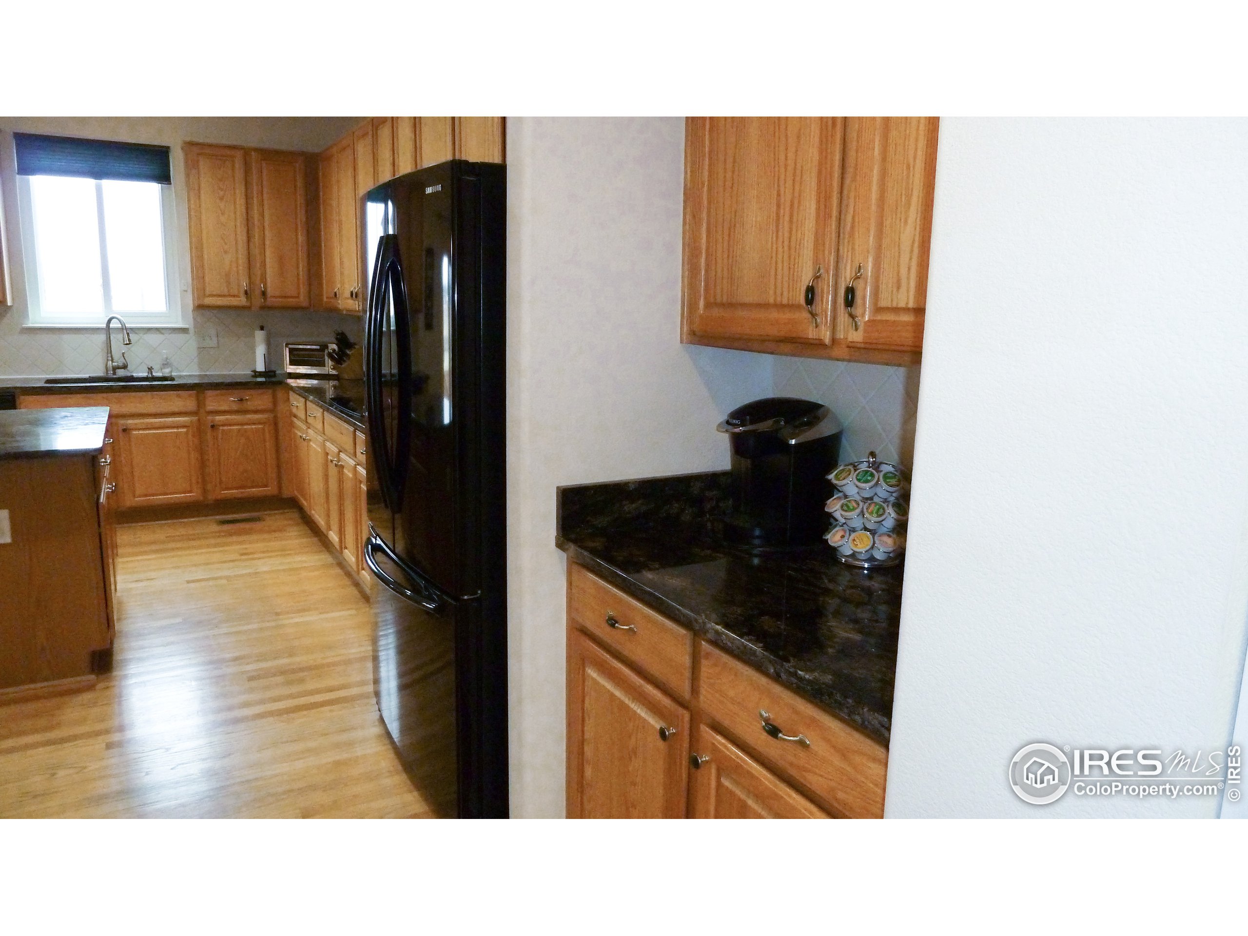 8121 Raspberry Drive Frederick, CO 80504 - Photo 7 of 38 a kitchen with a refrigerator and a cabinets