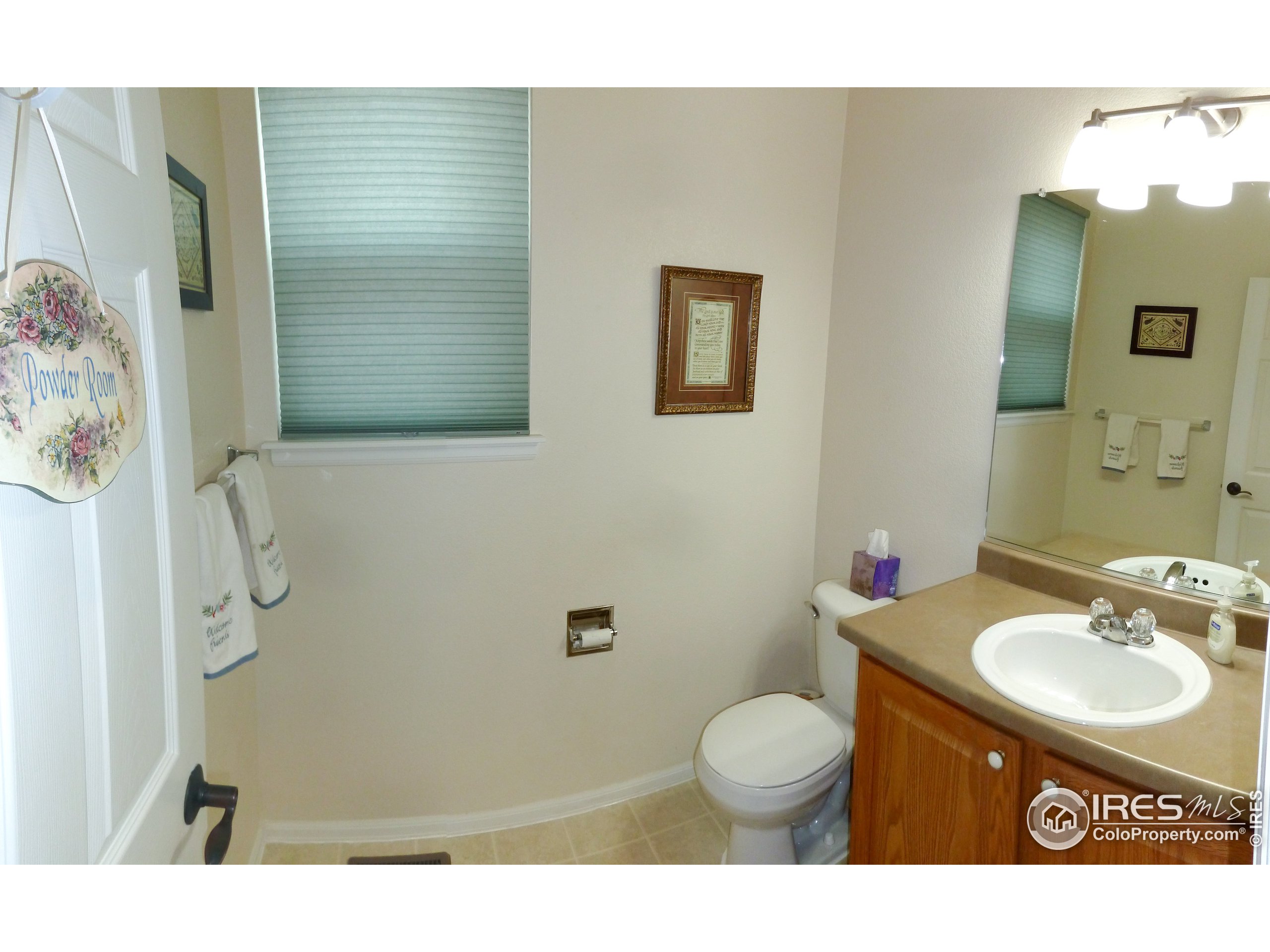 8121 Raspberry Drive Frederick, CO 80504 - Photo 10 of 38 a bathroom with a granite countertop sink toilet a mirror and shower