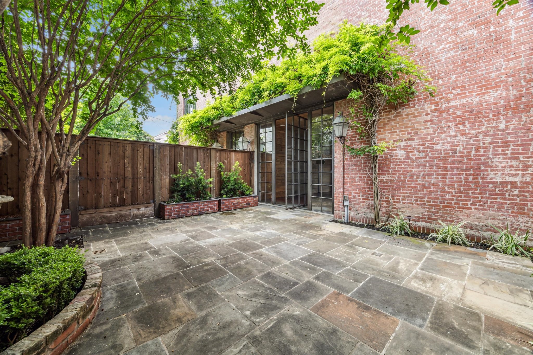 808 Coronado Street Houston, TX 77009 - Photo 15 of 50 a view of a house with a backyard and a garden