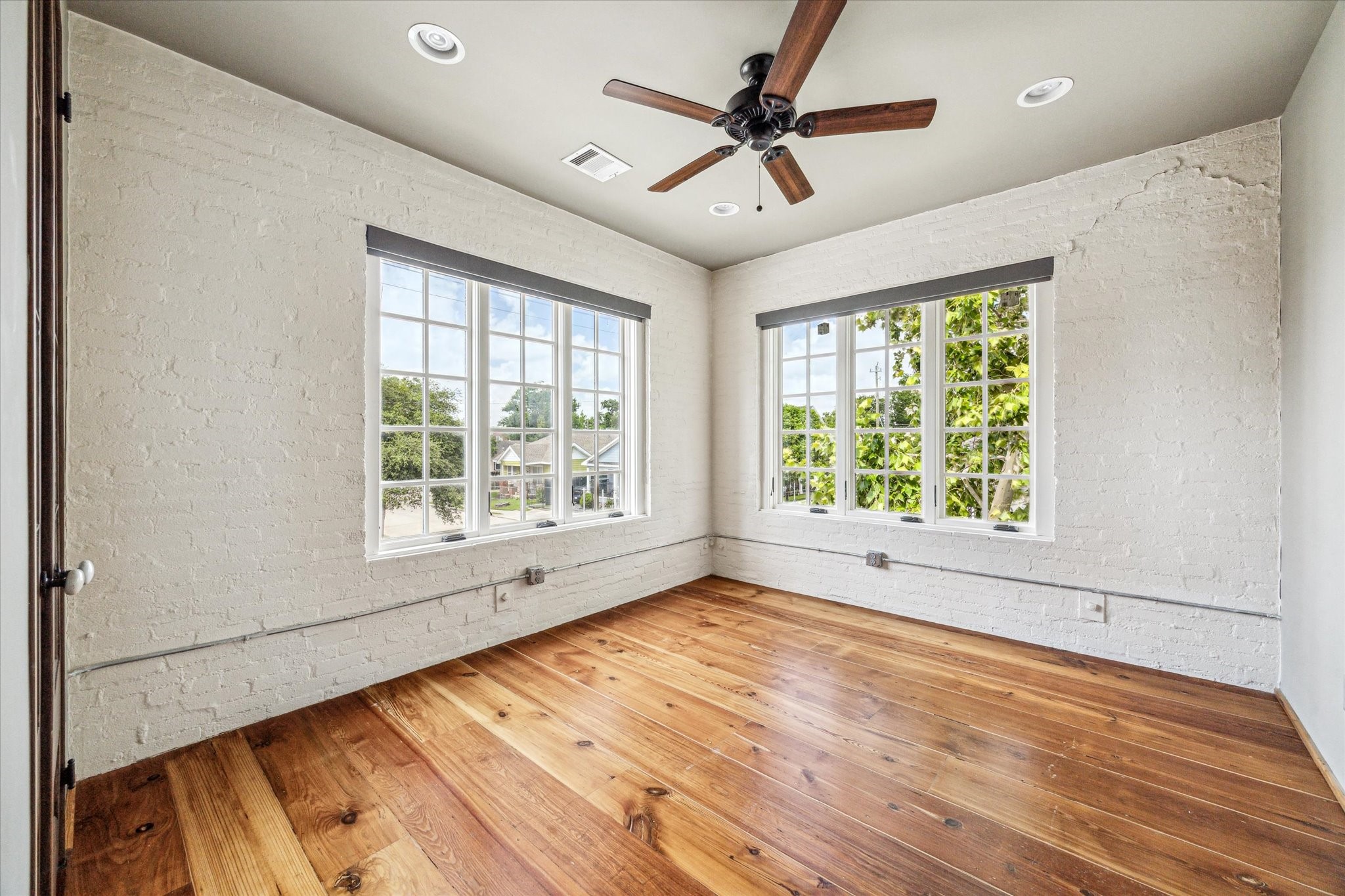 808 Coronado Street Houston, TX 77009 - Photo 16 of 50 a view of an empty room with a window and wooden floor