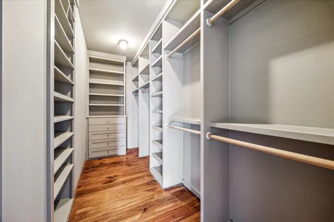 a view of walk in closet with empty racks