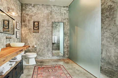a bathroom with a sink a vanity and a large mirror
