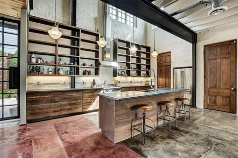 a kitchen with stainless steel appliances granite countertop lots of counter top space and wooden floor