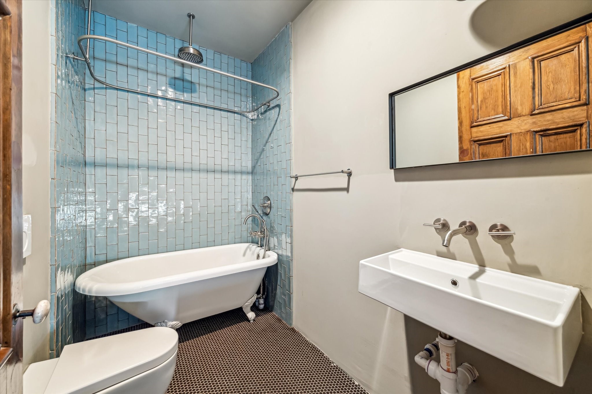 808 Coronado Street Houston, TX 77009 - Photo 46 of 50 a bathroom with a sink a toilet a mirror and shower