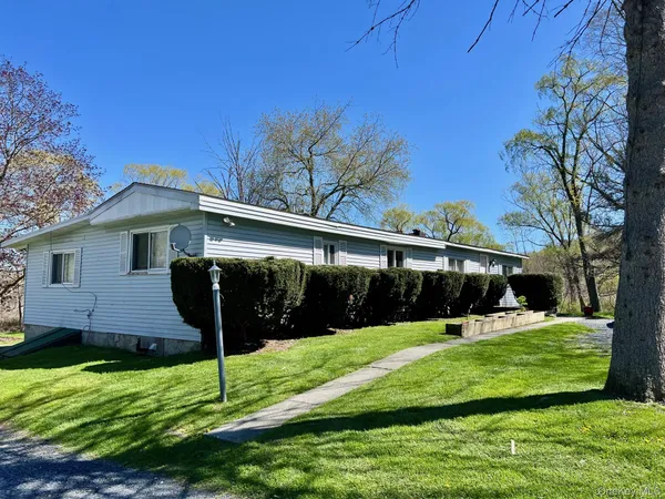 a view of house with a yard