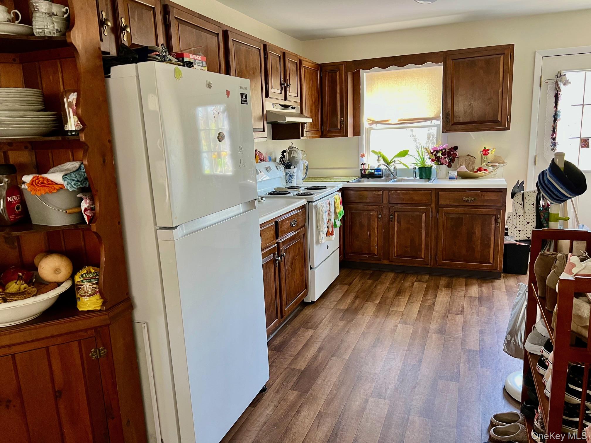 24 Wilson Eaton Road Amenia, NY 12501 - Photo 13 of 20 a kitchen with stainless steel appliances a stove a refrigerator a sink a oven with wooden floor and cabinets