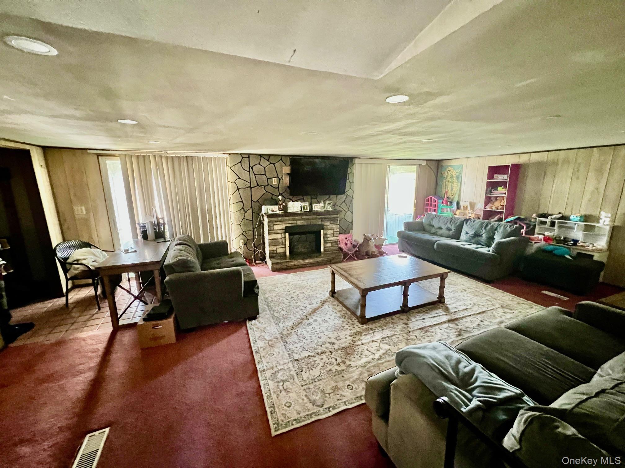 24 Wilson Eaton Road Amenia, NY 12501 - Photo 10 of 20 a living room with furniture flat screen tv and a fireplace