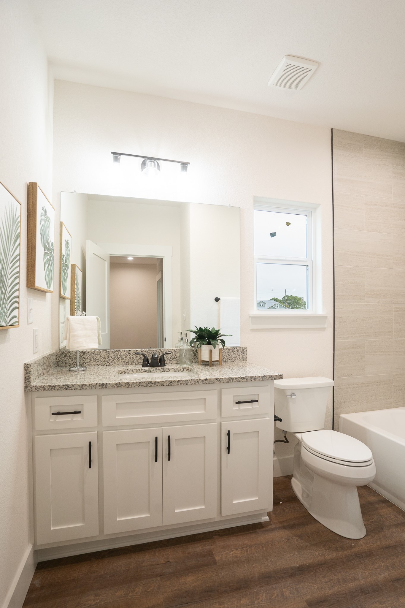304 String Prairie Way Smithville, TX 78957 - Photo 25 of 30 Bathroom featuring vanity, toilet, wood finished floors, and baseboards