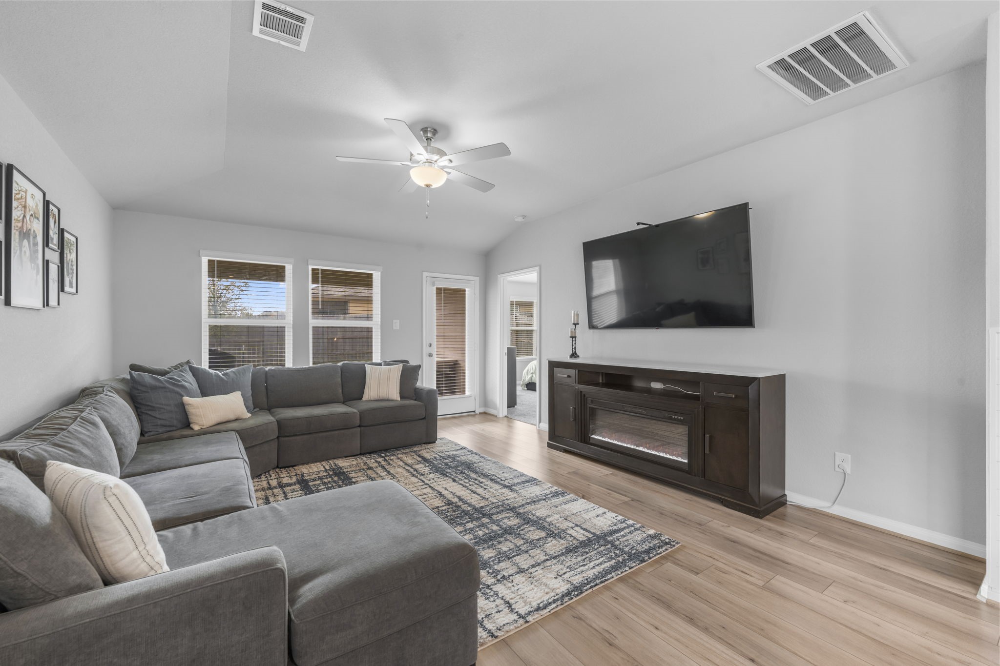 18581 Meadow Point Lane Montgomery, TX 77316 - Photo 14 of 44 a living room with furniture a flat screen tv and a fireplace