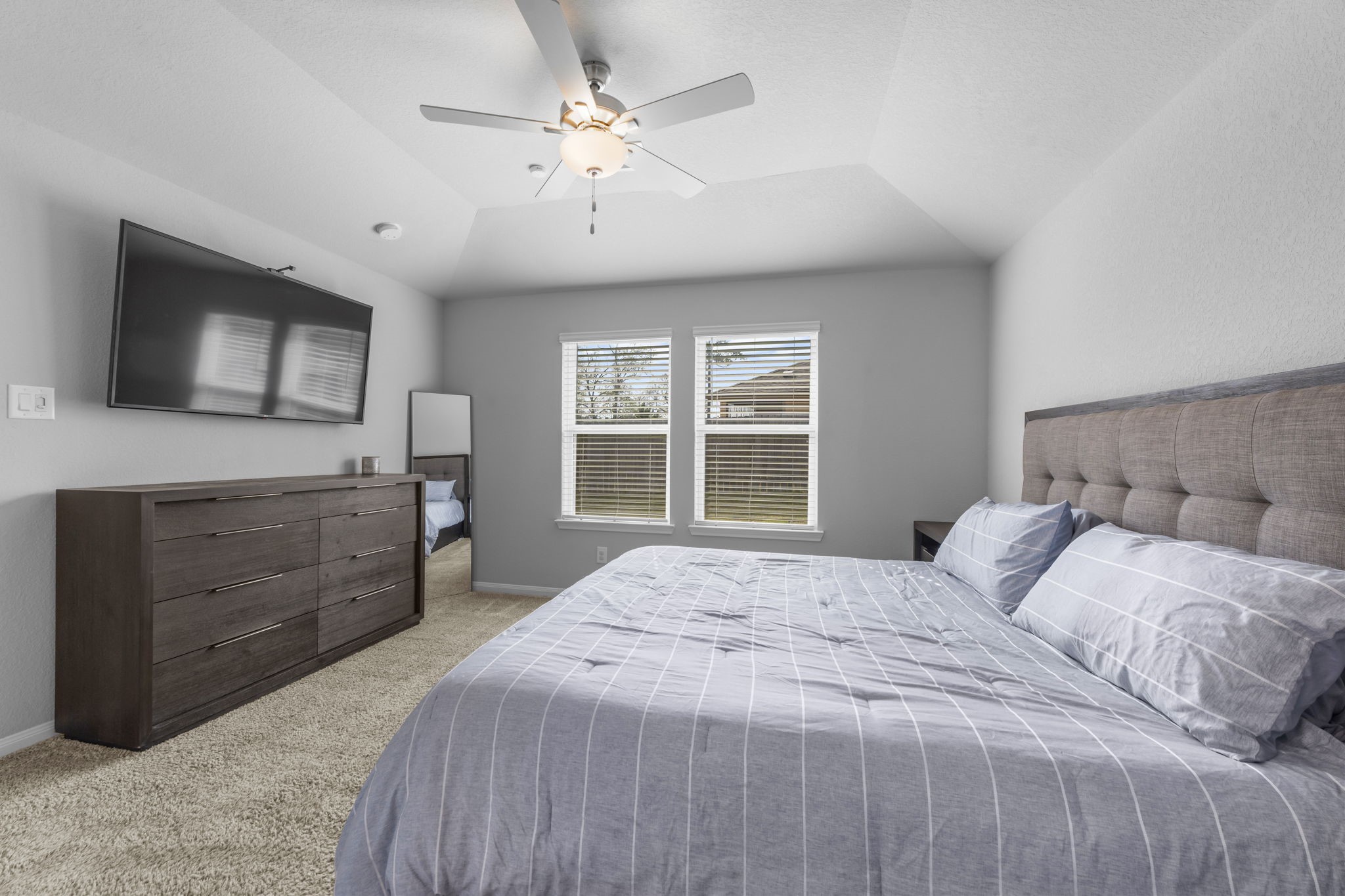 18581 Meadow Point Lane Montgomery, TX 77316 - Photo 20 of 44 a bedroom with a large bed and a flat screen tv