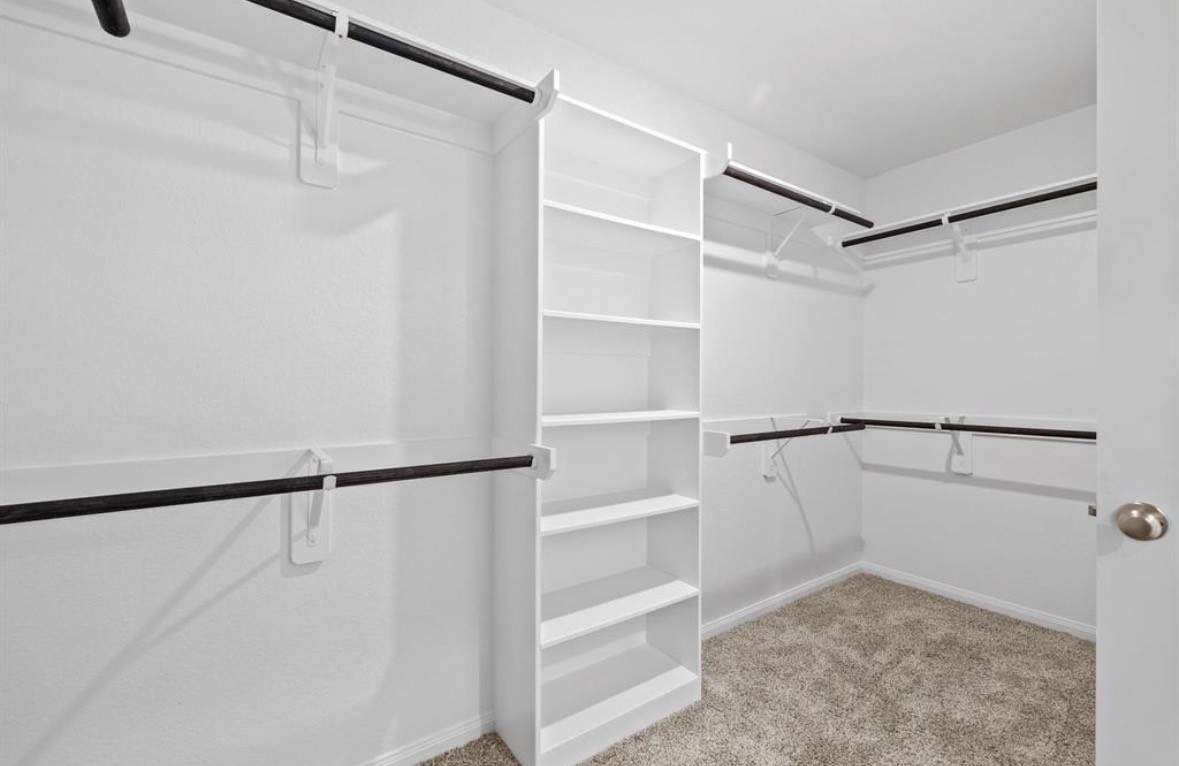 18581 Meadow Point Lane Montgomery, TX 77316 - Photo 21 of 44 a view of walk in closet with empty racks