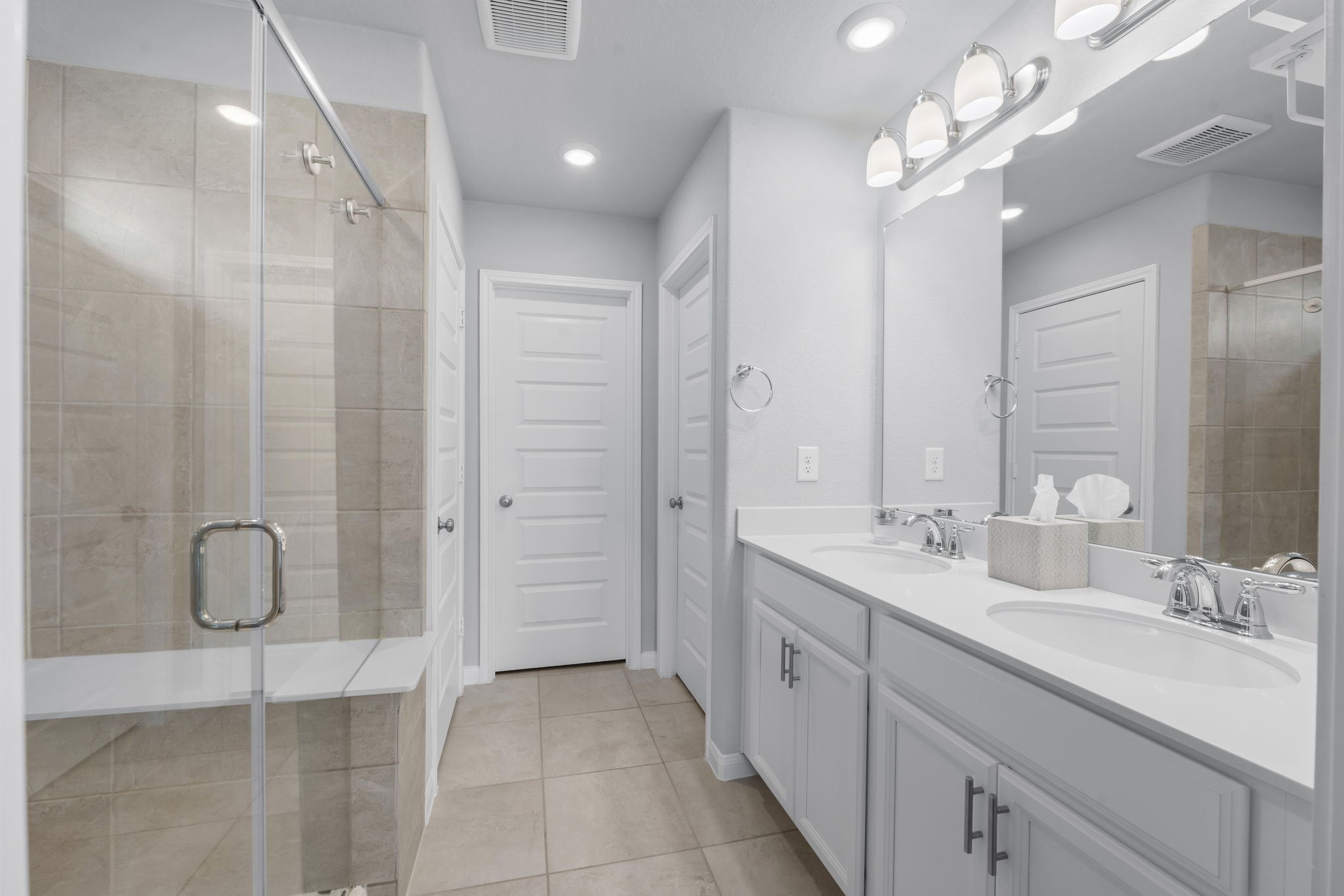18581 Meadow Point Lane Montgomery, TX 77316 - Photo 22 of 44 a spacious bathroom with a double vanity sink a large mirror and shower