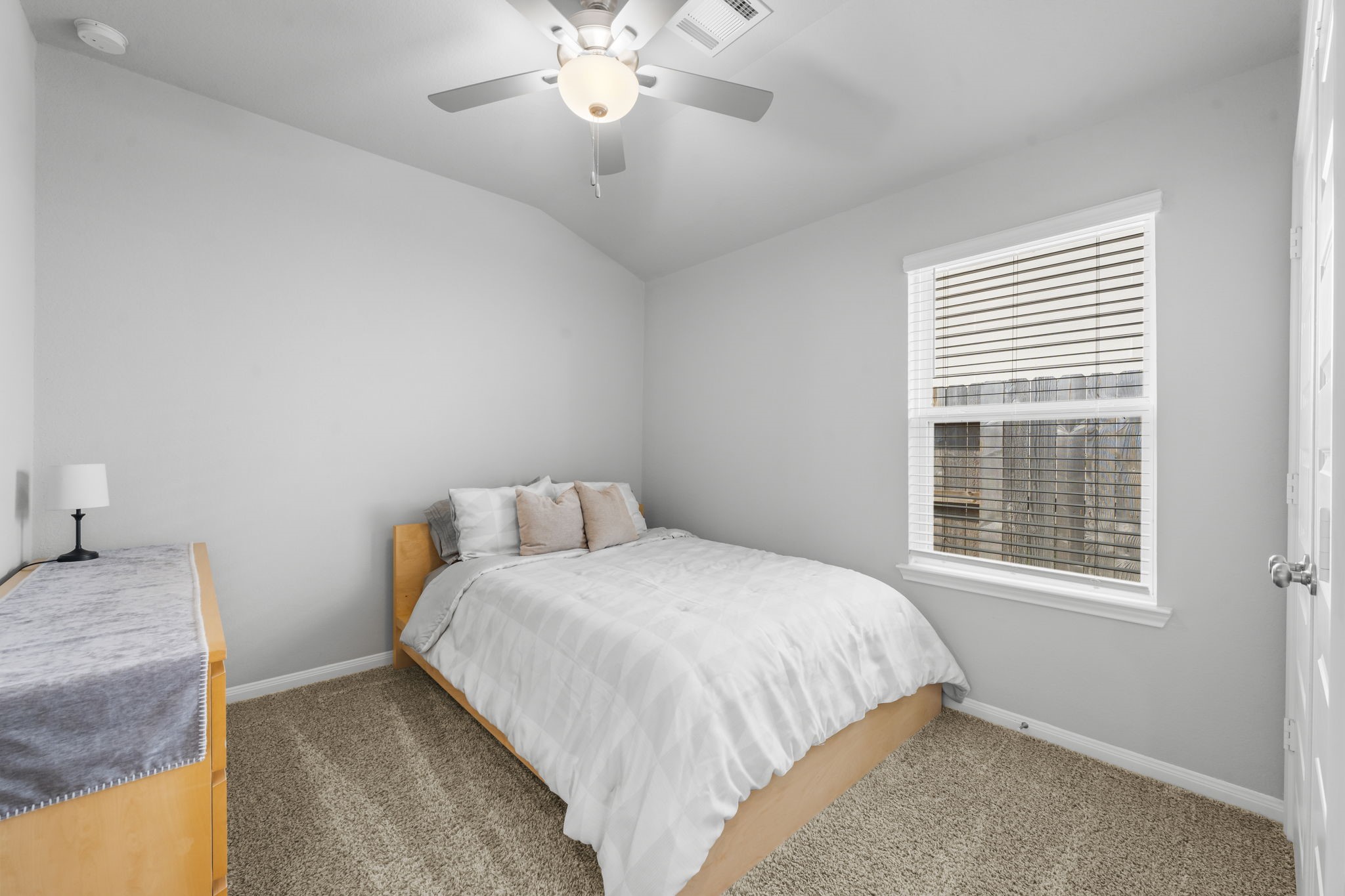 18581 Meadow Point Lane Montgomery, TX 77316 - Photo 25 of 44 a bedroom with a large bed and a chandelier