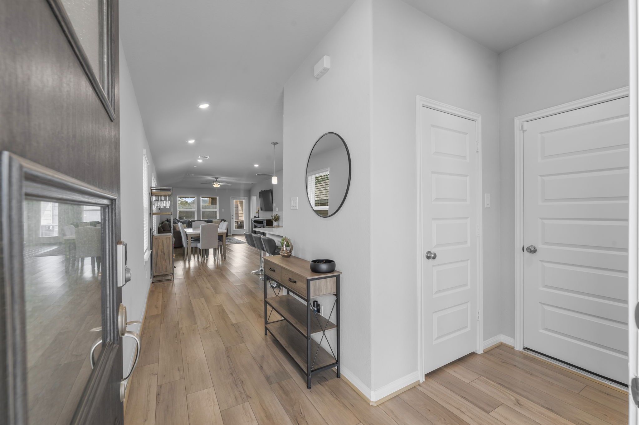 18581 Meadow Point Lane Montgomery, TX 77316 - Photo 4 of 44 a hallway with wooden floor table and chairs