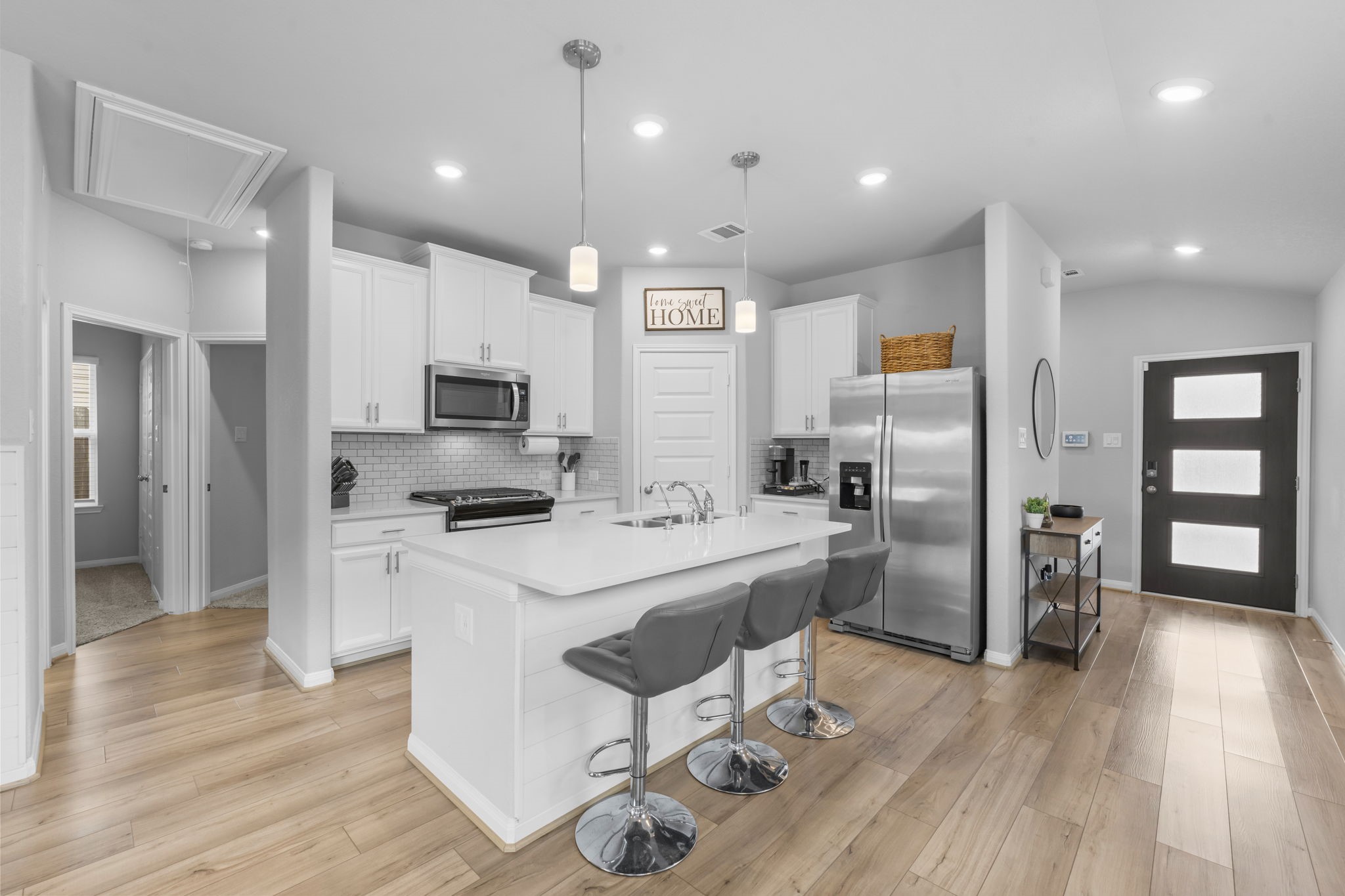 18581 Meadow Point Lane Montgomery, TX 77316 - Photo 6 of 44 a kitchen with stainless steel appliances a refrigerator stove microwave and cabinets