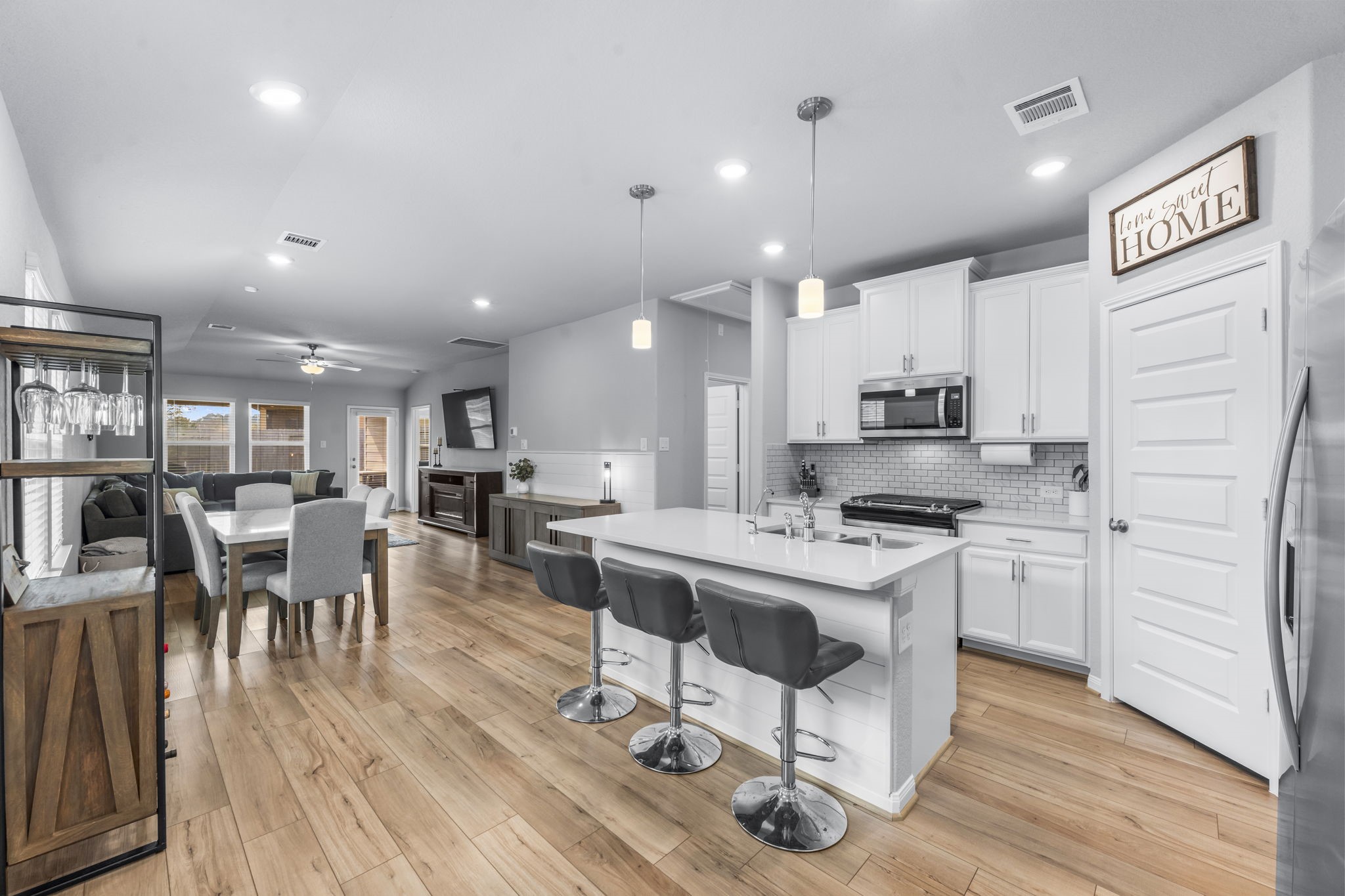 18581 Meadow Point Lane Montgomery, TX 77316 - Photo 10 of 44 a kitchen with stainless steel appliances a stove a sink a refrigerator cabinets and wooden floor