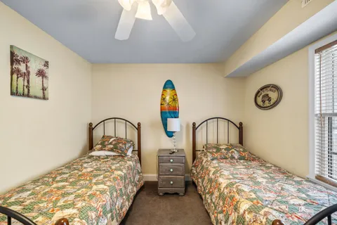 a bedroom with two beds and a window
