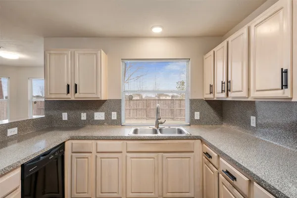 a kitchen with a sink cabinets and window