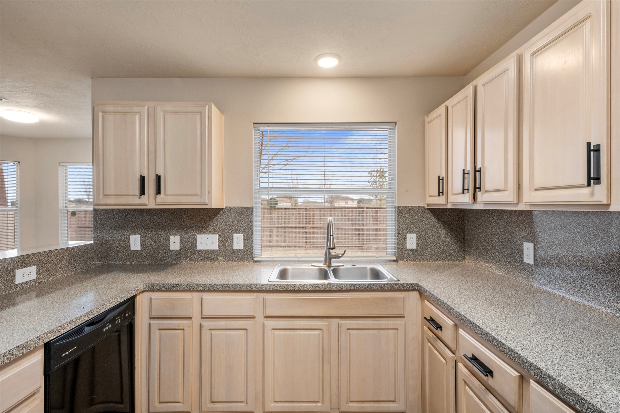 13615 Ambrose Street Houston, TX 77045 - Photo 13 of 35 a kitchen with a sink cabinets and window