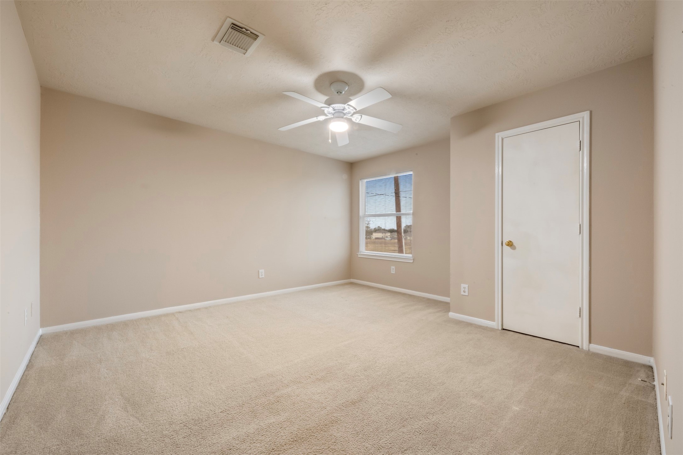 13615 Ambrose Street Houston, TX 77045 - Photo 16 of 35 an empty room with a chandelier fan and windows