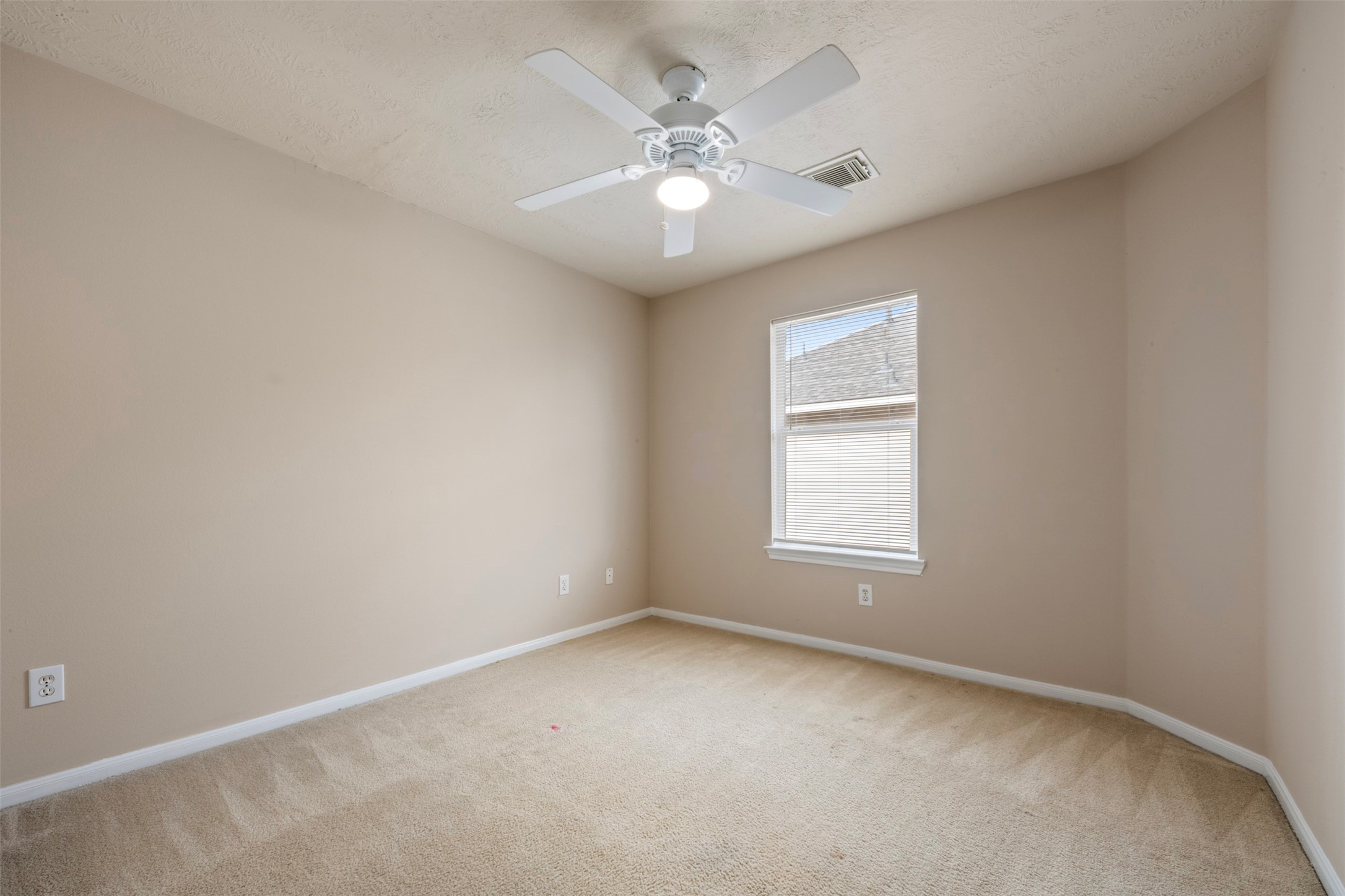 13615 Ambrose Street Houston, TX 77045 - Photo 18 of 35 an empty room with windows and chandelier fan