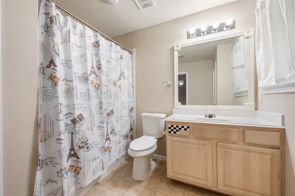 a spacious bathroom with a sink a toilet and a mirror