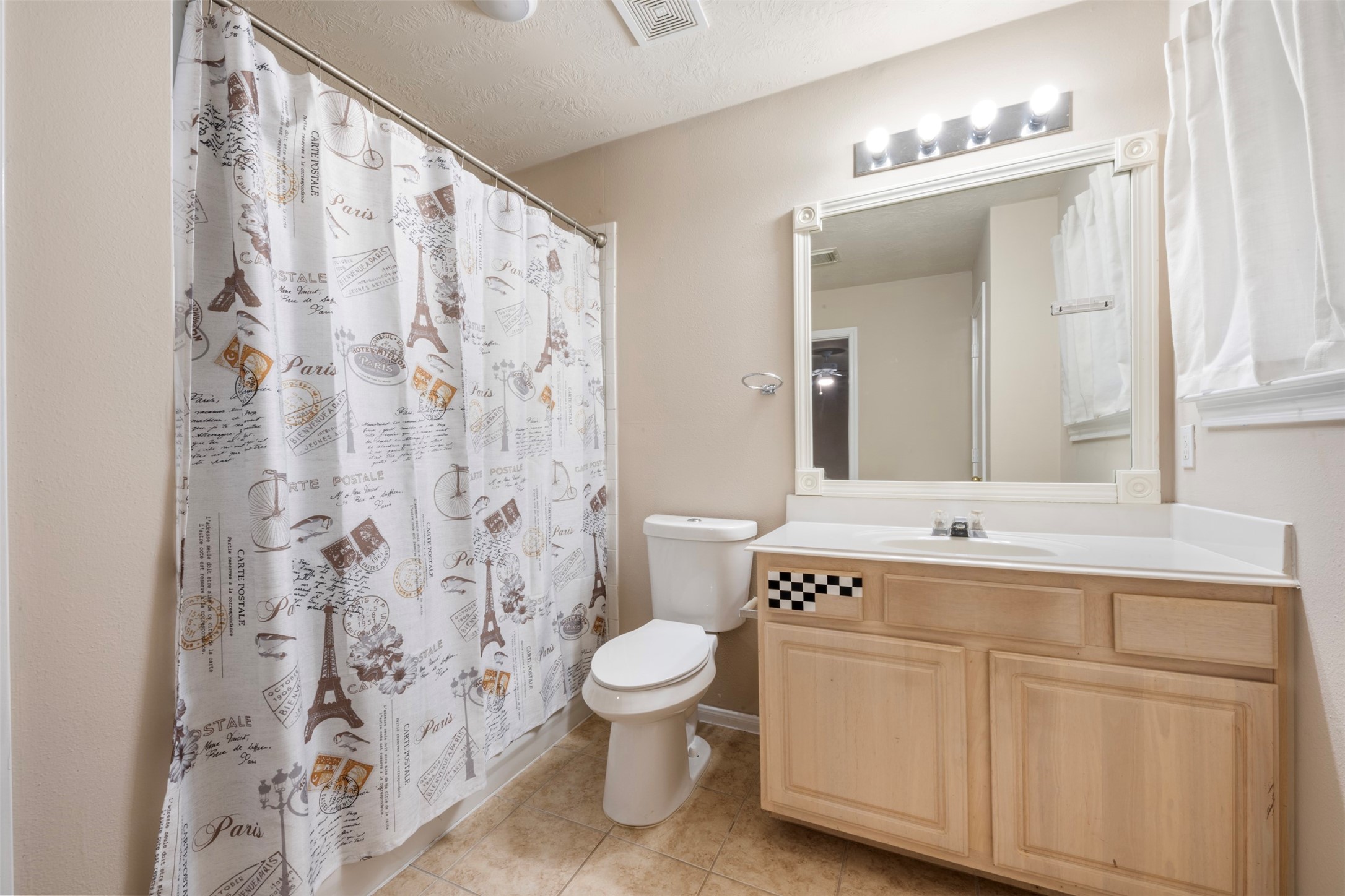 13615 Ambrose Street Houston, TX 77045 - Photo 21 of 35 a spacious bathroom with a sink a toilet and a mirror