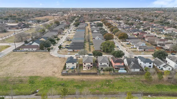 an aerial view of residential houses with outdoor space and swimming pool
