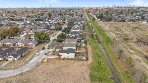 an aerial view of residential houses with outdoor space