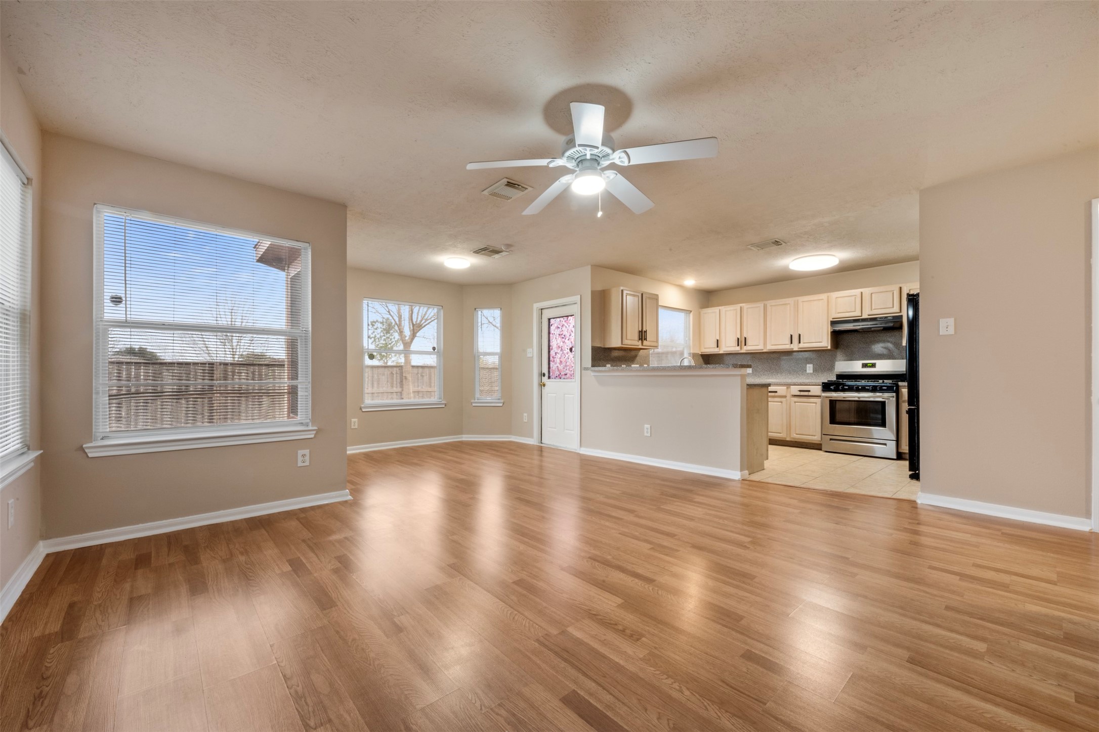 13615 Ambrose Street Houston, TX 77045 - Photo 7 of 35 a view of an empty room with wooden floor and a window