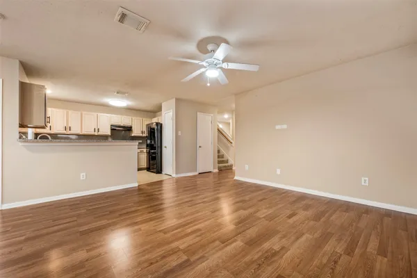 a view of a kitchen with wooden floor and a kitchen