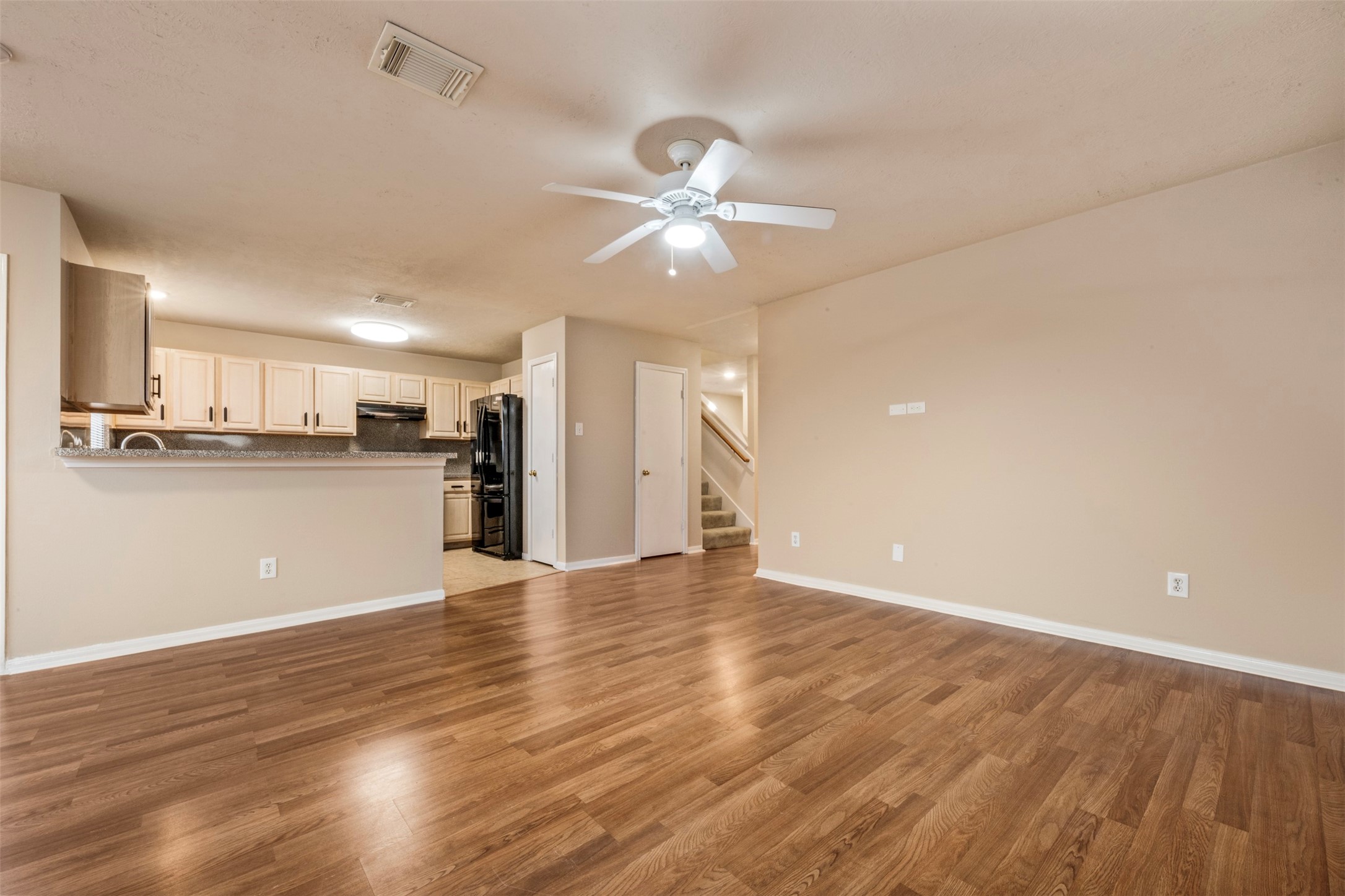 13615 Ambrose Street Houston, TX 77045 - Photo 8 of 35 a view of a kitchen with wooden floor and a kitchen