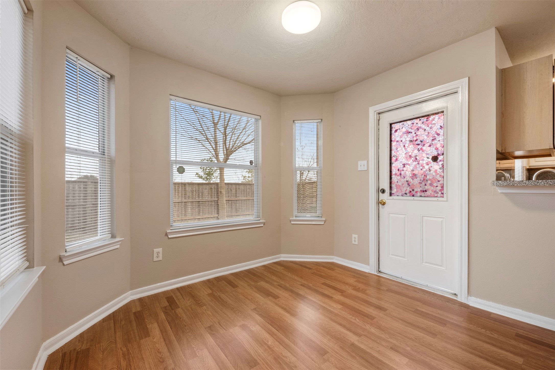13615 Ambrose Street Houston, TX 77045 - Photo 9 of 35 a view of an empty room with wooden floor and a window