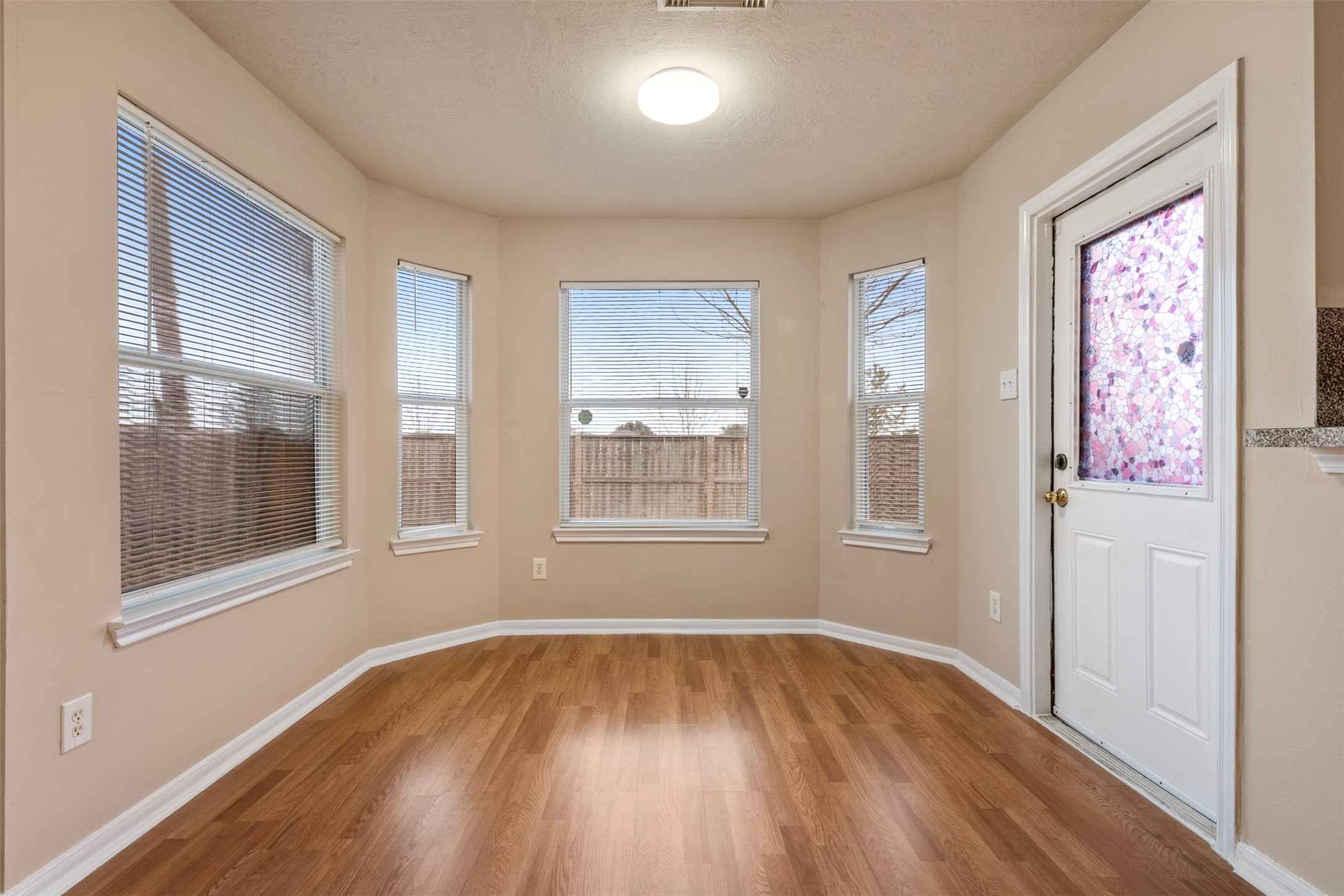 13615 Ambrose Street Houston, TX 77045 - Photo 10 of 35 a view of an empty room with wooden floor and a window