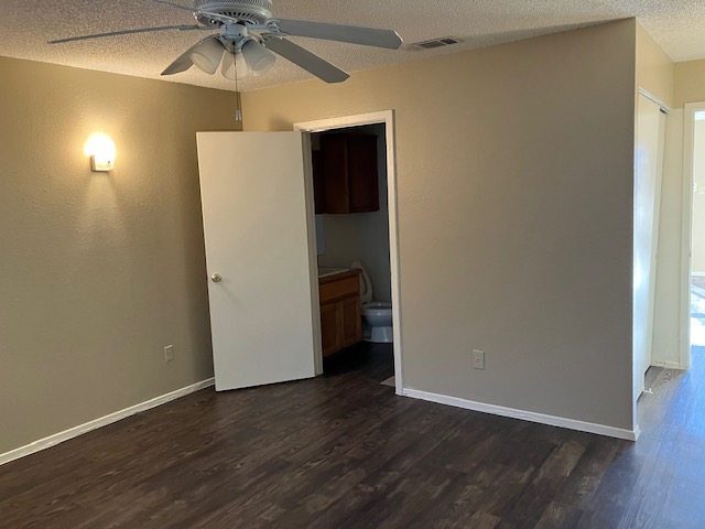2306 East 8th Street, Unit 5 Austin, TX 78702 - Photo 5 of 9 an empty room with wooden floor and fan