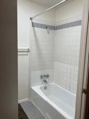 a bathroom with a bathtub and shower