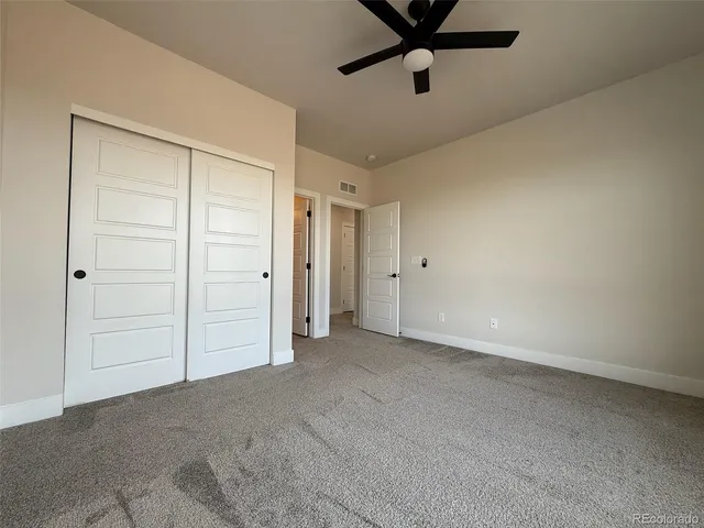 a view of a livingroom with a ceiling fan and window