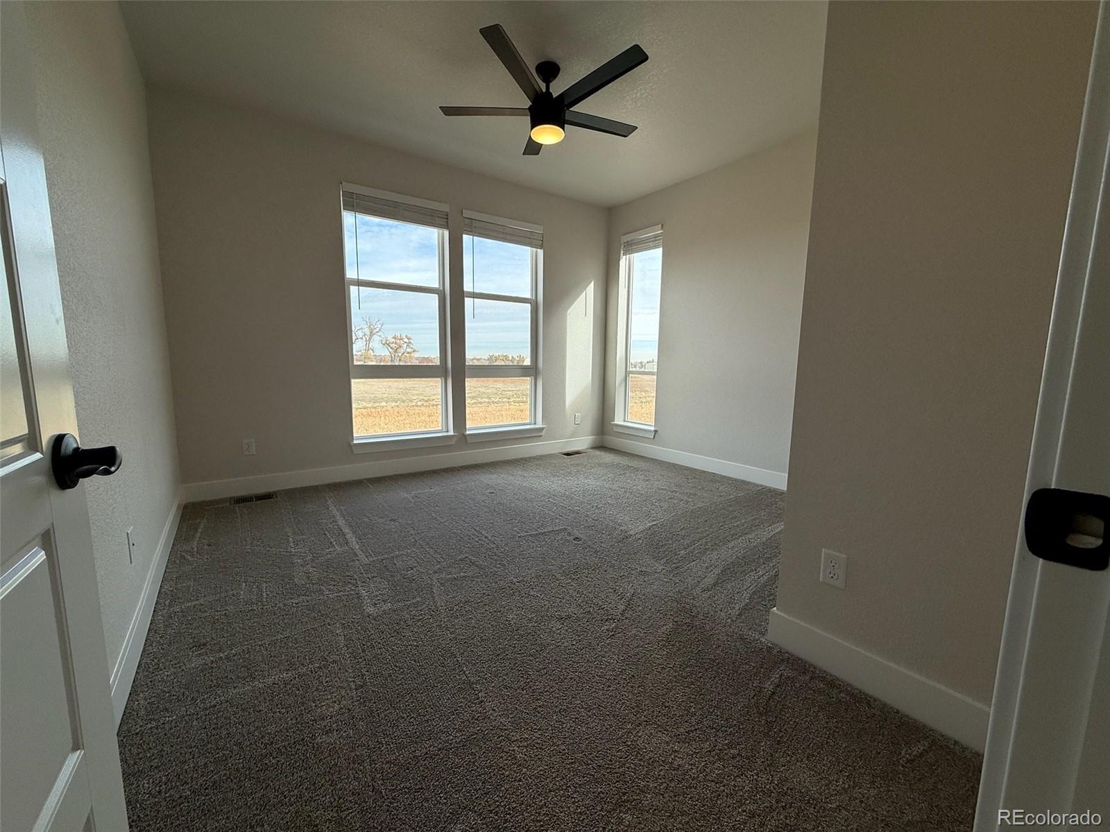12355 Farmview Lane Thornton, CO 80241 - Photo 35 of 42 a view of a livingroom with a ceiling fan and window