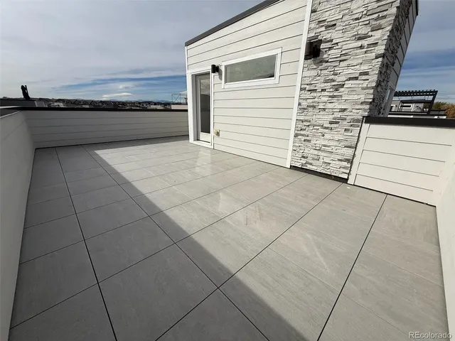 a front view of a house with a yard and outdoor seating