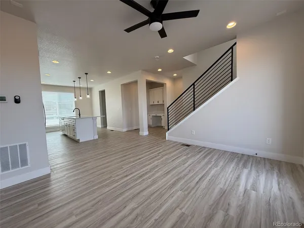 a view of a room with wooden floor and windows
