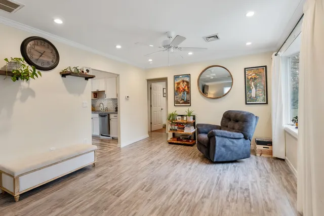 a living room with furniture and a wooden floor