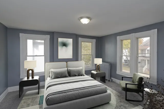 a bedroom with furniture and a large window