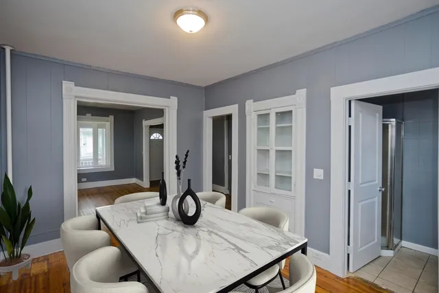 a view of a kitchen area with furniture and wooden floor