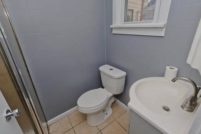 a white toilet sitting next to a sink