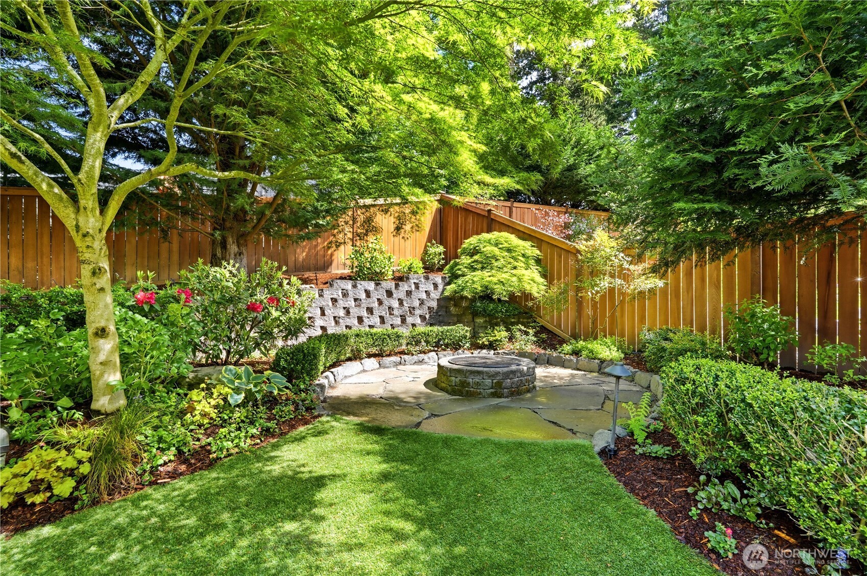 13410 Southeast 252nd Street Kent, WA 98042 - Photo 18 of 38 a view of a garden with a bench