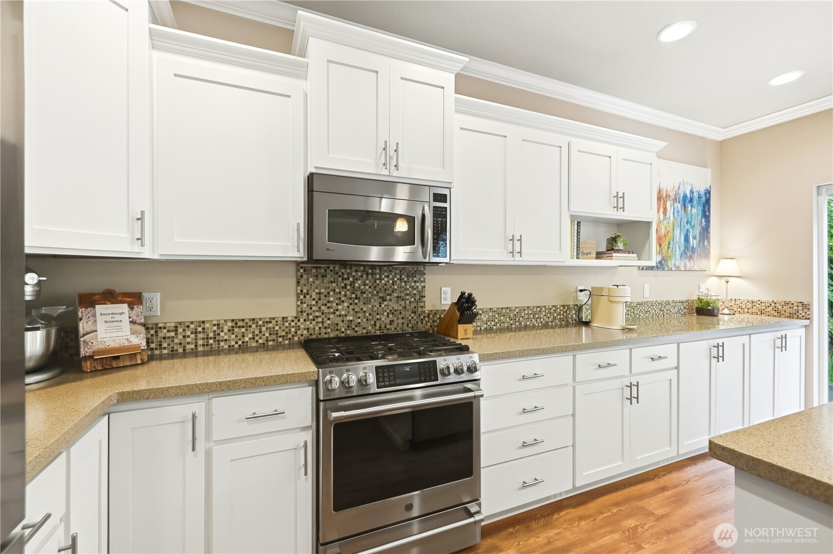 13410 Southeast 252nd Street Kent, WA 98042 - Photo 22 of 38 a kitchen with granite countertop white cabinets and stainless steel appliances